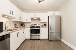 Dieppe apartment for rent - a kitchen with white cabinets and stainless steel appliances