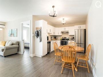 Dieppe apartment for rent - A kitchen with a table and chairs in the middle of the room.