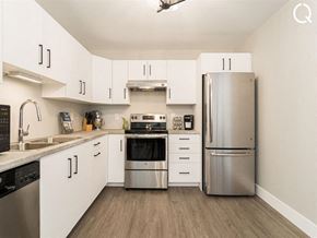 Dieppe apartment for rent - a kitchen with stainless steel appliances and white cabinets
