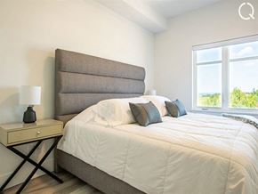 Dieppe apartment for rent - a bedroom with a large bed and a large window