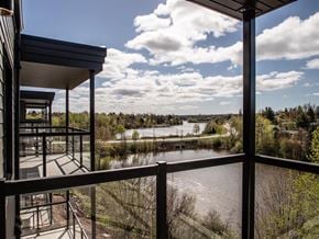 Moncton apartment for rent - a view of a river from a balcony overlooking a lake