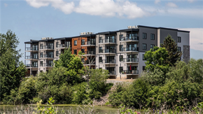 Moncton apartment for rent - an apartment building on the side of a river