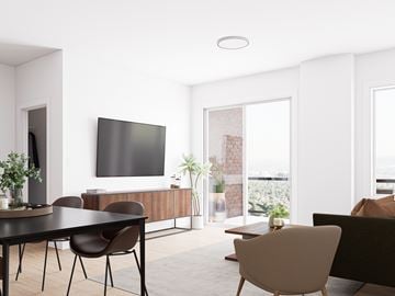 Dieppe apartment for rent - A modern living room with a flat screen TV, a black table and brown chairs.