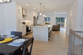 Dieppe townhouse for rent - A modern kitchen with a dining table set for two.