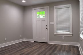 Birmingham house for rent - A room with a white door and a window with blinds.