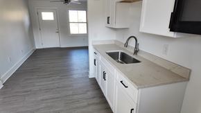 Birmingham apartment for rent - A kitchen with white cabinets and a marble countertop.