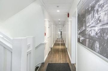 Vancouver apartment for rent - A long hallway with a black and white picture on the wall.