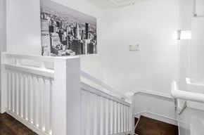 Vancouver apartment for rent - A black and white photograph of a cityscape is displayed on a white wall above a white radiator.