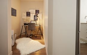 St. Albert apartment for rent - a bedroom with a desk with a chair and a white rug