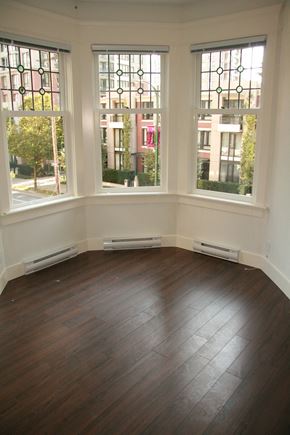Vancouver apartment for rent - A room with a window overlooking a street.
