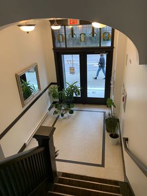 Vancouver apartment for rent - A hallway with a potted plant on the floor.
