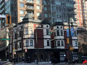Vancouver apartment for rent - A street view of a building with a red and white facade.
