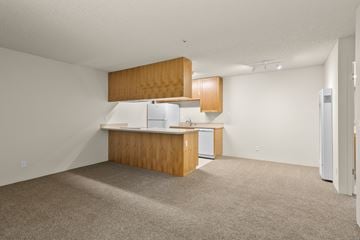 Santa Rosa apartment for rent - A kitchen with white appliances and wooden cabinets.