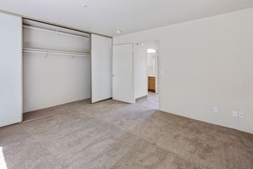 Rohnert Park apartment for rent - the living room and bedroom of an apartment with white walls and carpet