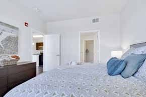 Denver apartment for rent - A bedroom with a large bed and a dresser.