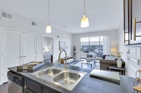 Denver apartment for rent - A modern kitchen with a large sink and a view of the city.