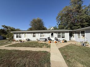Glasford apartment for rent - A house with a white exterior and a grey roof with a small front yard.