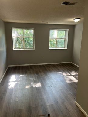 Eldorado apartment for rent - A room with two windows and wood flooring.
