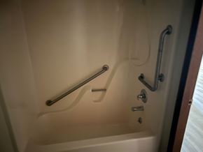 Harrisburg apartment for rent - A white bathtub with a silver grab bar on the side.