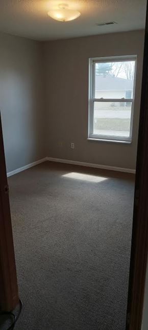 Mt. Carmel apartment for rent - A room with a carpeted floor and a window.