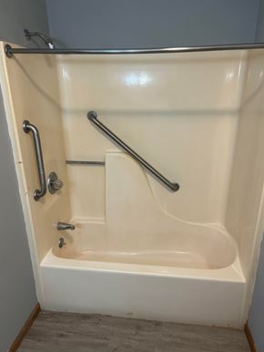 Stonefort apartment for rent - A white bathtub with silver fixtures in a bathroom.