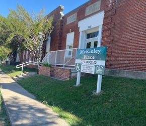 Harrisburg apartment for rent - A sign for McKinley Place stands in front of a brick building.