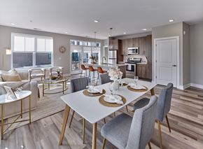 Little Falls apartment for rent - A modern dining room with a white table and grey chairs.