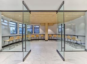 Little Falls apartment for rent - A conference room with glass walls and wooden ceiling.