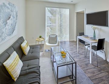 Seattle apartment for rent - a living room and dining room with a couch and a table