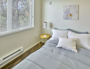 Seattle apartment for rent - a bedroom with a bed and a large window