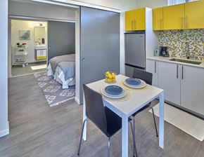 Seattle apartment for rent - a kitchen and dining area with a table and chairs and a bedroom