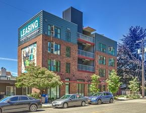 Seattle apartment for rent - a building with a sign on the side of a street