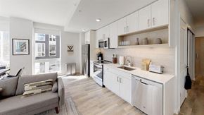 Seattle apartment for rent - a kitchen and living room with a sink and refrigerator