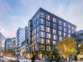 Seattle apartment for rent - a rendering of a tall building on a city street