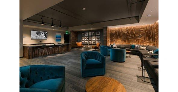 Seattle apartment for rent - a living room with blue chairs and a bar