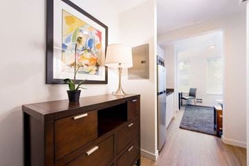 Seattle apartment for rent - a living room and dining room with a lamp and a painting