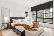 Stamford apartment for rent - a bedroom with a large bed and a large window