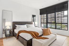 Stamford apartment for rent - a bedroom with a large bed and a large window