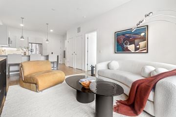 Stamford apartment for rent - A living room with a yellow chair and a white couch.