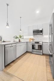 Stamford apartment for rent - a modern kitchen with stainless steel appliances and white cabinets
