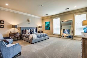 Dallas apartment for rent - A bedroom with a large bed and a couch.