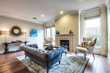 Dallas apartment for rent - A living room with a blue couch and a fireplace.