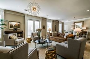 Dallas apartment for rent - A living room with a grey sofa, a coffee table, and a chandelier.