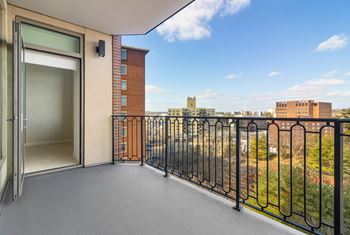 A balcony with a door and a view of the city