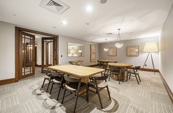 A conference room with tables and chairs and a tripod