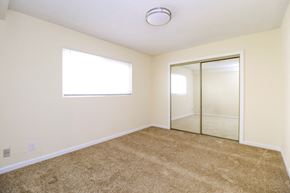 Oakland apartment for rent - A room with a carpeted floor and a sliding glass door.