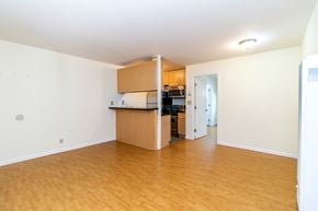 Oakland apartment for rent - A kitchen area with wooden floors and cabinets.
