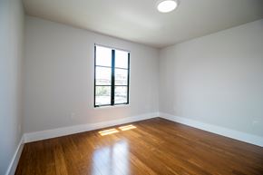 Berkeley apartment for rent - A room with a window and wooden floors.