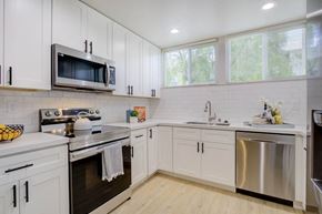 Belmont apartment for rent - a kitchen with white cabinets and stainless steel appliances