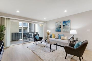 Belmont apartment for rent - a living room with a couch and chairs and a sliding glass door to a balcony